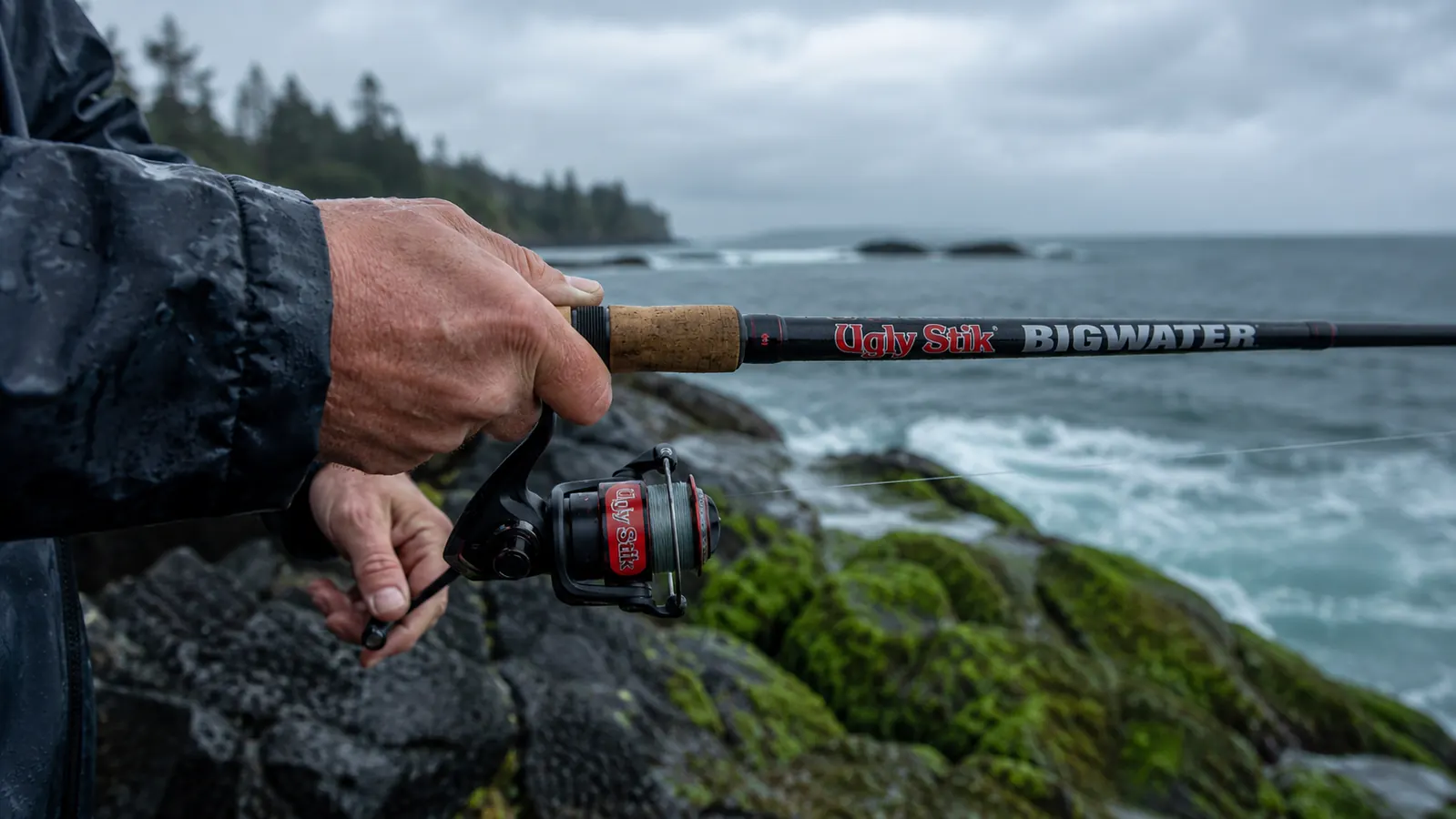A hand casting the Ugly Stik Bigwater combo from a rocky jetty
